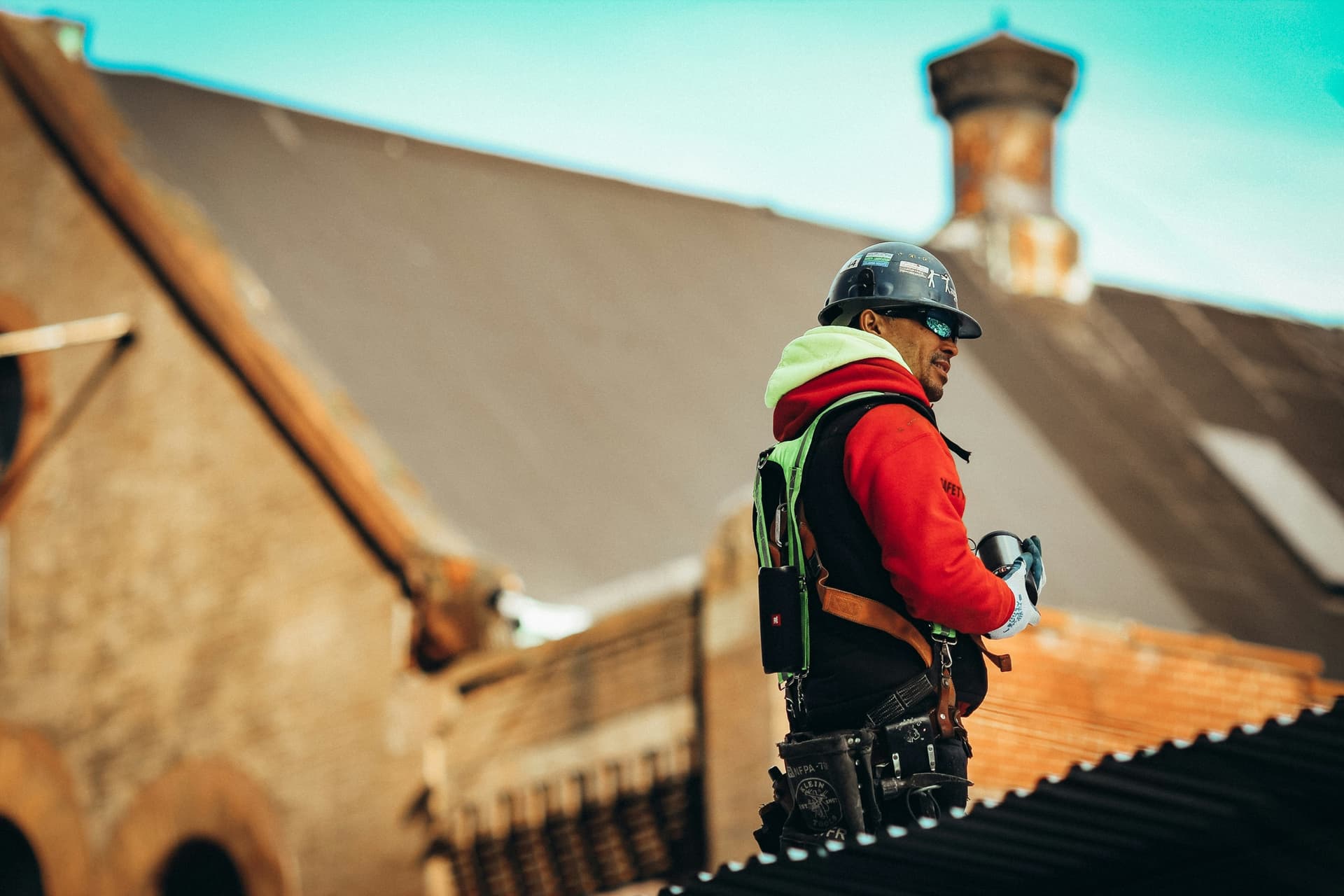 Roofing professional using fall protection while working on a residential roof