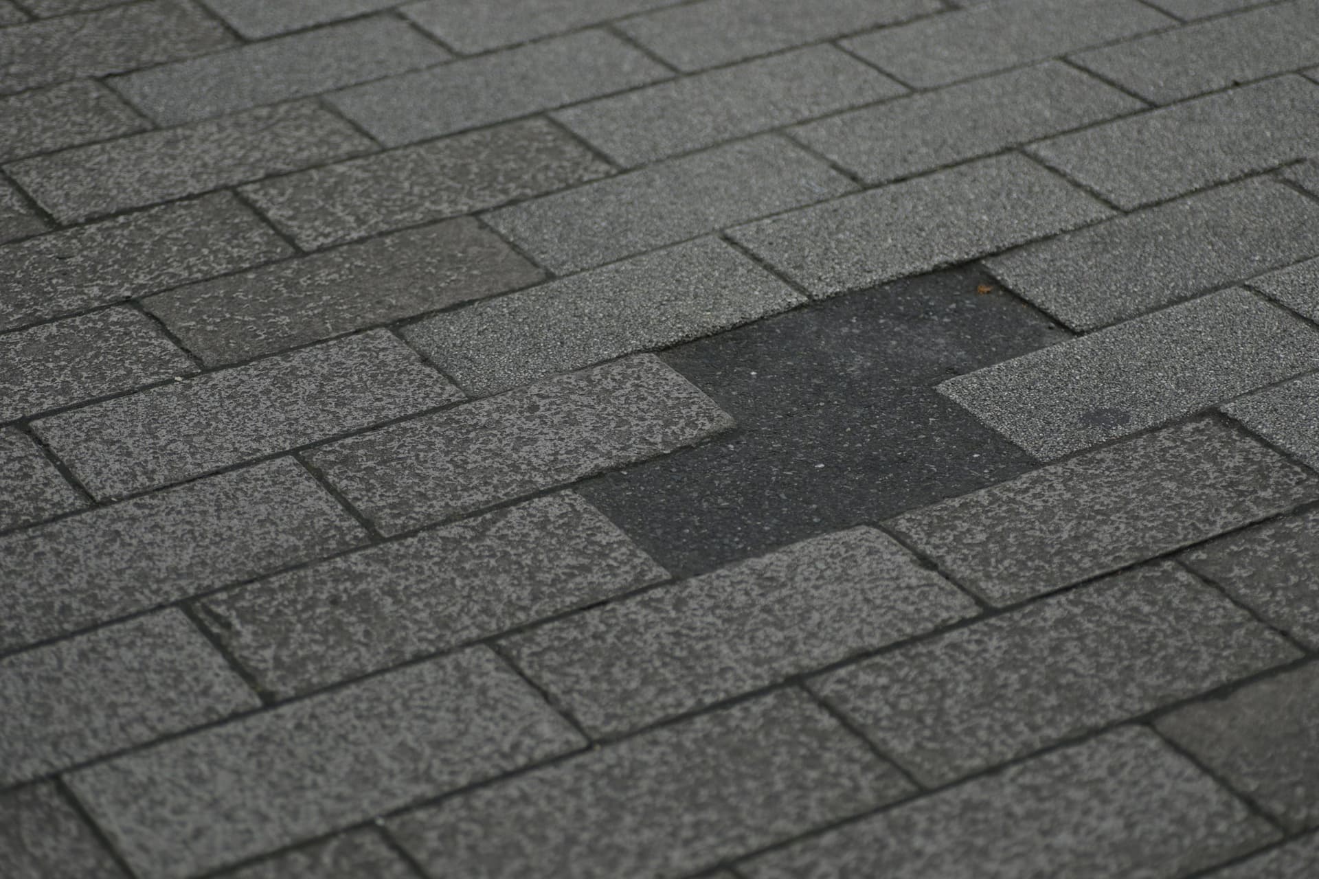 Asphalt shingle roof with a missing shingle